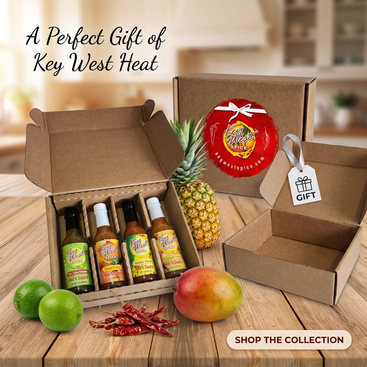 A gift set of four Key West Heat hot sauce bottles in a brown cardboard box, displayed on a wooden table with fresh ingredients like a pineapple, mango, limes, and red chilies. The image includes text overlays reading 'A Perfect Gift of Key West Heat' and 'SHOP THE COLLECTION'.