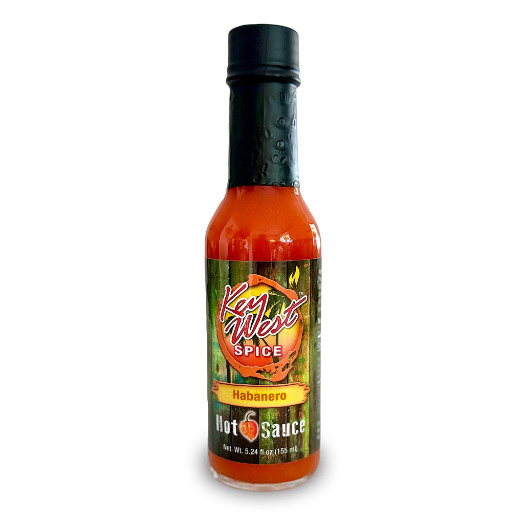 A bottle of Key West Spice Habanero Hot Sauce on a white background, featuring a black cap and a green label with red and yellow text.