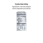 Key West Spice Paradise Steak Grilling seasoning packet with vibrant label and grilling spices on a rustic background.