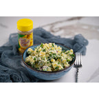 Banana Fusion salt-free, sugar-free spice blend from Key West Spice, shown in a jar alongside a potato salad dish.