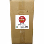 Bulk Key West Spice hulled white sesame seeds in a clear jar, showing small, smooth, white sesame seeds ready for cooking or baking.
