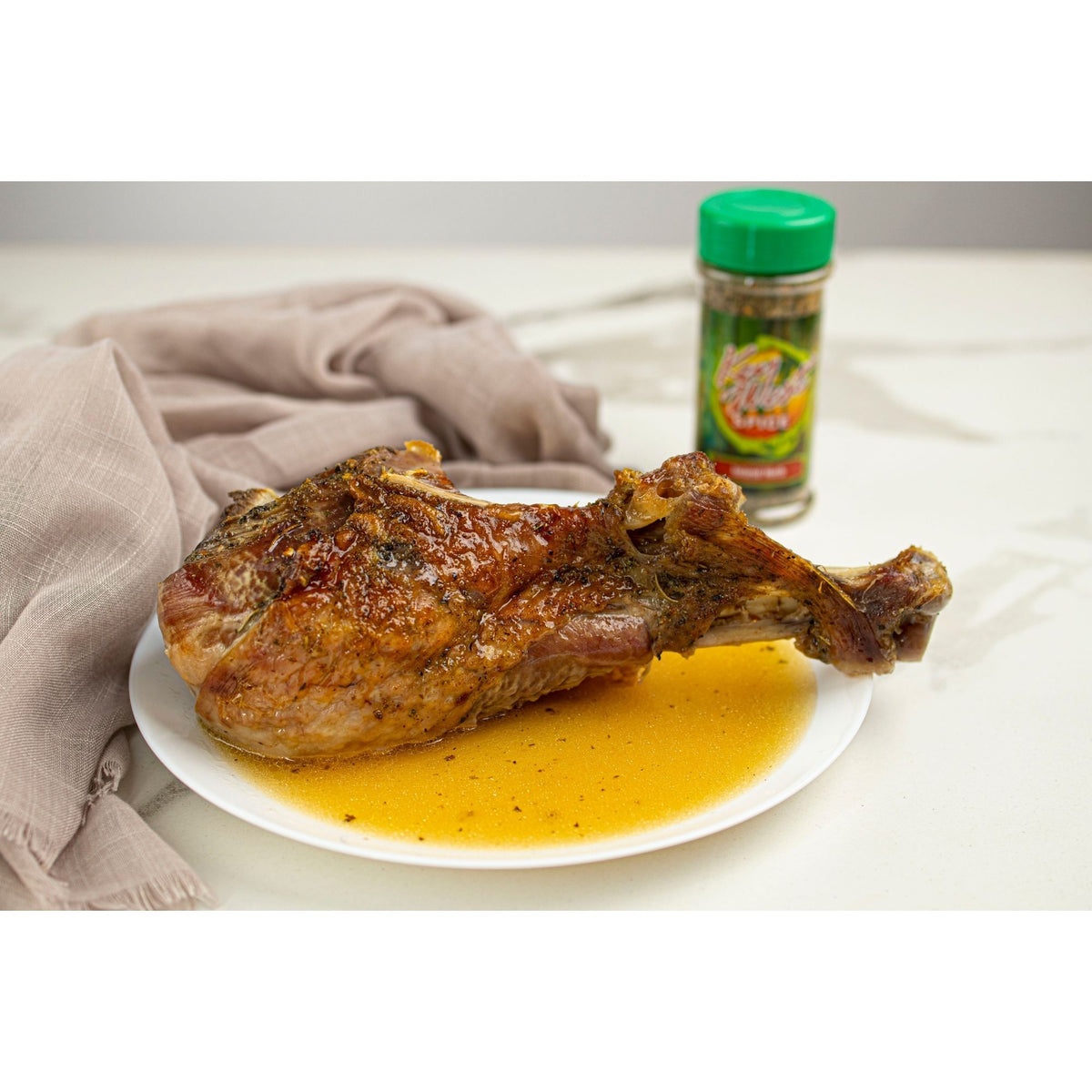Key West Spice Island Herb salt-free, sugar-free seasoning on a turkey leg, showing fresh herbs and seasoning blend.
