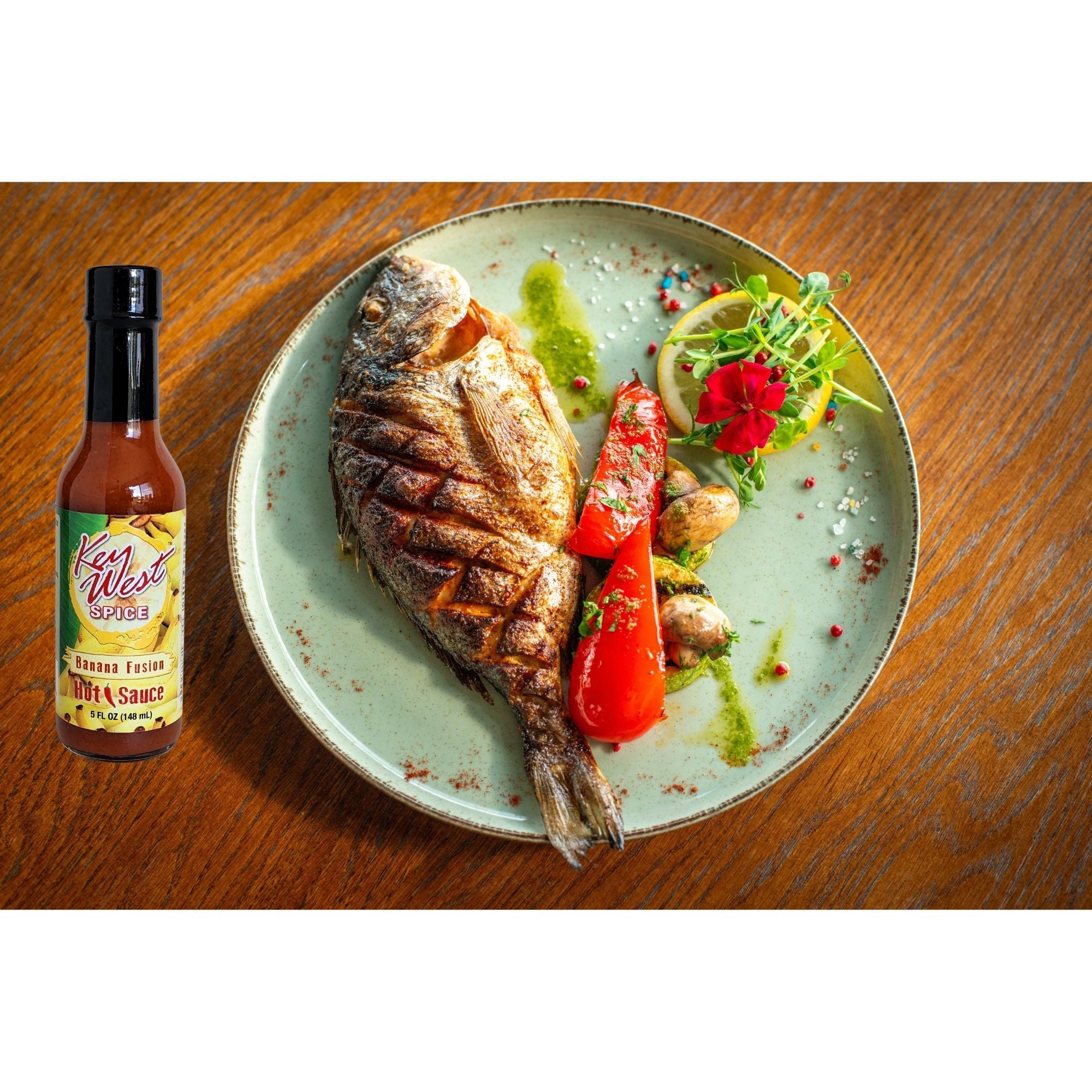 Key West Spice Banana Fusion Hot Sauce in 5 oz bottle, featuring a vibrant label and the spicy, fruity sauce inside.