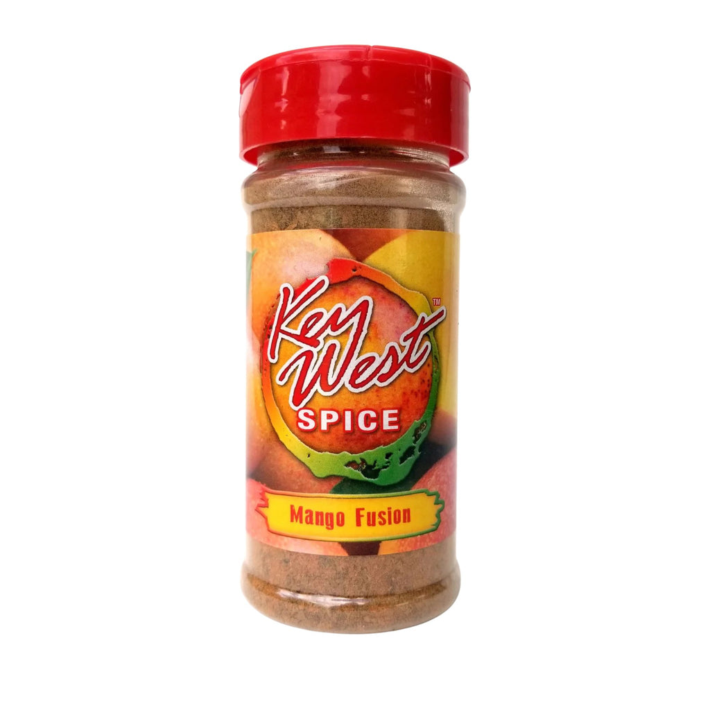 Key West Spice Mango Fusion salt-free and sugar-free seasoning in a 5 oz jar with fresh mango chunks and vibrant spices.