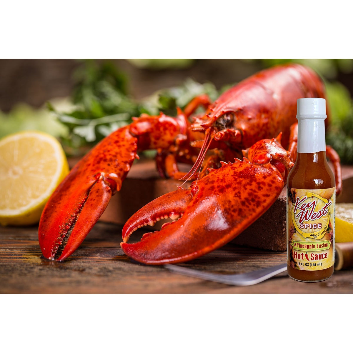 Key West Spice Pineapple Fusion Hot Sauce bottle with lobster illustration, 5 oz., featuring vibrant pineapple and fiery flavor branding.