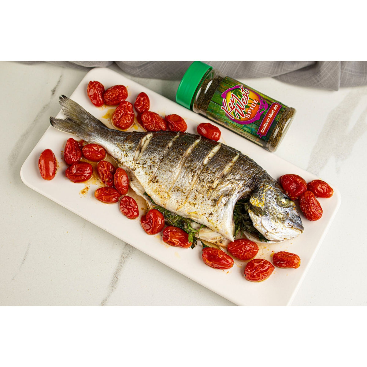 Key West Spice Southern Most Jerk fish, seasoned with spices, grilled to perfection, served on a plate with vibrant garnishes.